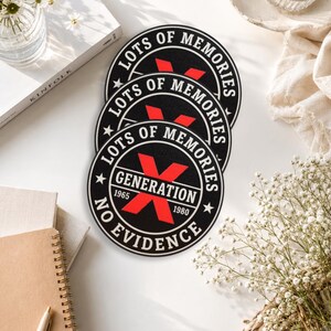 May include: Three circular black embroidered patches featuring a red X graphic. The text reads LOTS OF MEMORIES, GENERATION X, 1965, 1980, and NO EVIDENCE. The design includes white borders and stars, with a bold red X centered behind the text.