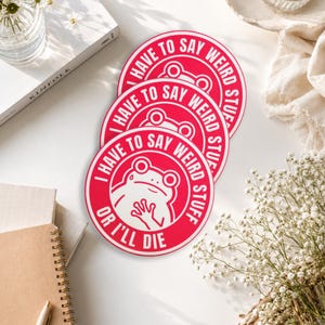 May include: Three circular stickers with a bright red background and white border. Each sticker features a white line-art illustration of a frog and the text "I HAVE TO SAY WEIRD STUFF OR I'LL DIE" printed in a circular pattern around the frog.