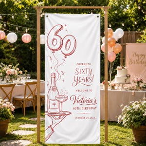 May include: A vertical white banner featuring red line art of a champagne bottle, a glass, and balloons shaped like the number 60. Text reads: Cheers to Sixty Years, Welcome to Victoria's 60th Birthday, and October 24, 20XX, printed in red ink.