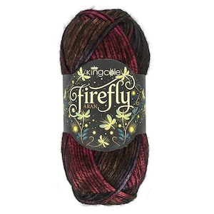 May include: A skein of King Cole Firefly Aran yarn featuring a variegated blend of deep black, dark red, and metallic copper tones. A black paper label wraps around the center, displaying the text King Cole Firefly Aran with gold dragonfly illustrations.