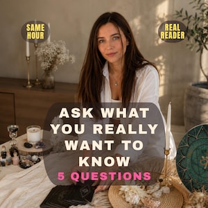 May include: A person with long brown hair wearing a white shirt sits behind a table with tarot cards, candles, and crystals. Text on the image reads: SAME HOUR, REAL READER, ASK WHAT YOU REALLY WANT TO KNOW, 5 QUESTIONS in white and pink lettering.