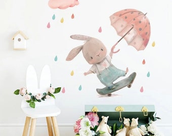 vinyl wall sticker of cute cartoon rabbit with umbrella. Perfect for Nursery’s, bedrooms or playrooms this decal will brighten any room