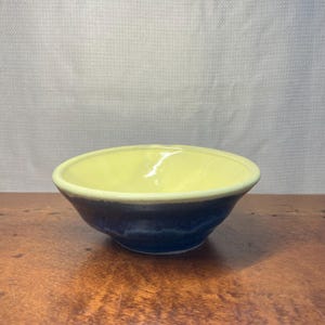 Handcrafted Pottery Bowl with Butter Yellow Interior and Deep Blue Glaze Stamped MF WI 26