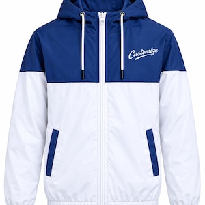 Puede incluir: Una chaqueta cortavientos de dos colores con una sección superior azul oscuro y una sección inferior blanca. La chaqueta tiene una capucha con cordones blancos, una cremallera frontal blanca completa y dos bolsillos laterales. La palabra Customize está impresa en blanco.