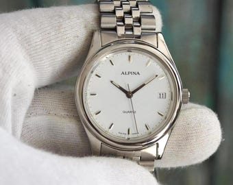 Reloj Alpina de cuarzo vintage de 34 mm, fabricado en Suiza, con ventana de fecha y brazalete de acero inoxidable. En perfecto estado. Batería nueva.