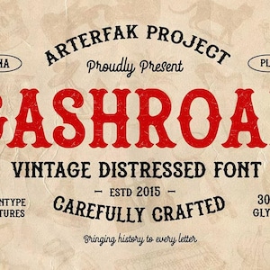 May include: A digital graphic display for the GASHROAD vintage distressed font. The text reads ARTERFAK PROJECT Proudly Present GASHROAD VINTAGE DISTRESSED FONT ESTD 2015 CAREFULLY CRAFTED. The word GASHROAD is in large red letters on a beige background.
