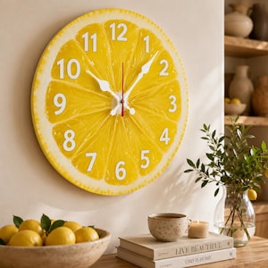 May include: A round wall clock featuring a vibrant yellow lemon slice design with white numerals from 1 to 12. The clock has white hour and minute hands and a thin red second hand centred on the face, mimicking the texture of citrus fruit pulp.
