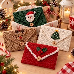 May include: Four crocheted envelope-style pouches featuring holiday motifs: a green pouch with a Santa Claus face, a tan pouch with a reindeer face, a white pouch with a Christmas tree, and a red pouch with holly berries, each with a wooden button.