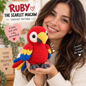 May include: A crochet pattern for Ruby the Scarlet Macaw featuring a red, yellow, and blue stuffed bird with a yellow beak and black eyes. The text reads: Ruby the Scarlet Macaw Crochet Pattern, A little bird with a big personality!, Crochet Create Be Happy!