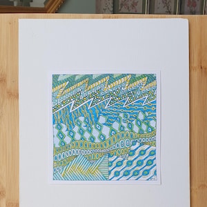 May include: A square drawing on white paper featuring intricate geometric patterns in shades of blue, green, and yellow. The design includes horizontal bands of zigzags, circles, diamonds, and parallel lines, creating a dense, layered visual texture.
