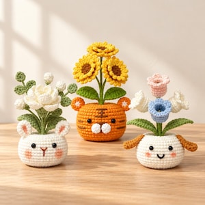 May include: Three crocheted potted plants featuring animal-shaped bases. The left is a white rabbit with white flowers, the center is an orange tiger with yellow sunflowers, and the right is a white puppy with pink and blue flowers.
