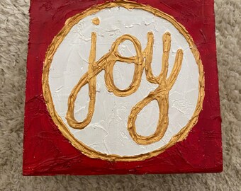 Bloque de madera texturizado con alegría navideña