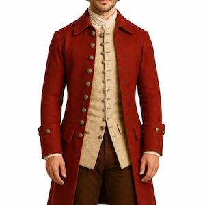 May include: A long, rust-red coat with a structured collar and metallic buttons, worn over a beige patterned waistcoat and a light-coloured shirt. The ensemble includes dark brown trousers, creating a layered outfit with a formal, historical aesthetic.