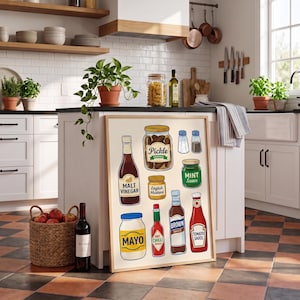 May include: A framed wall art print featuring colorful illustrations of various kitchen condiments including jars of pickles, mint sauce, and mayonnaise, alongside bottles of malt vinegar, English mustard, hot chili sauce, brown sauce, and tomato sauce.