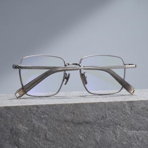 Titanium eyeglasses colour lineup for men in silver, gunmetal grey, black and black & gold, four lightweight square optical frames shown side by side as an everyday glasses colourway comparison.
