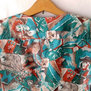 May include: A turquoise, brown, and red fabric with a repeating pattern of playing cards, letters, and abstract shapes. The fabric has a vintage feel and is perfect for crafting or sewing projects.