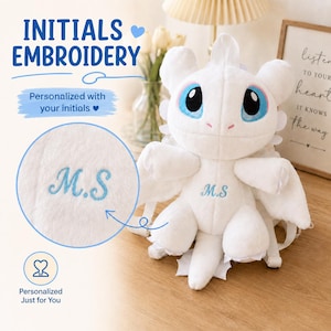 May include: A white plush dragon backpack featuring large blue eyes and embroidered initials M.S on the chest. The text INITIALS EMBROIDERY, Personalized with your initials, and Personalized Just for You is visible alongside a circular detail view.
