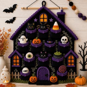 May include: A black and purple crocheted Halloween advent calendar shaped like a haunted house. It features twelve pockets, each containing a small crocheted figure including a ghost, pumpkin, skull, black cat, spider, candy corn, and eyeball.