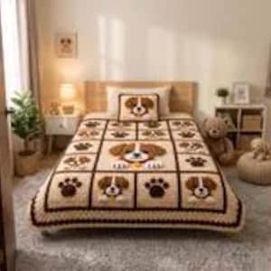 May include: A crocheted bedspread featuring a repeating grid pattern of brown and cream puppy faces and dark brown paw prints. The blanket has a scalloped border and includes a matching rectangular pillow with a central puppy face design.
