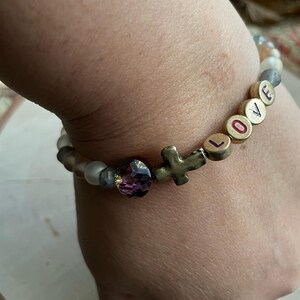 Love bracelet with variety of beads and cross charm