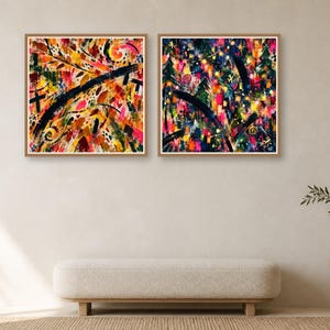 Two framed square abstract art prints hang side by side on a neutral wall above a long upholstered bench and a small side table.