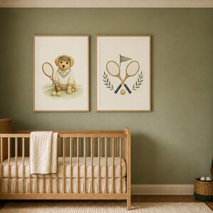 May include: Two framed wall art prints featuring tennis-themed illustrations. The left print shows a golden puppy wearing a visor and sweater holding a tennis racket. The right print displays two crossed tennis rackets, a flag, and laurel leaves.