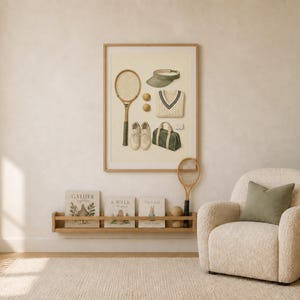May include: A framed wall art print featuring a vintage-style illustration of tennis equipment, including a wooden racket, a green visor, two tennis balls, a white V-neck sweater, a pair of white sneakers, and a green duffel bag on a cream background.