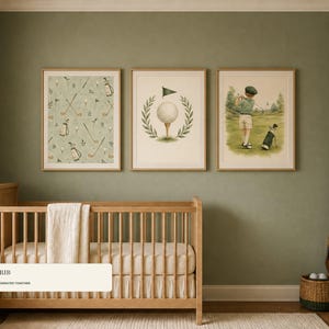 A wooden baby crib sits against a green wall below three framed watercolor golf prints.