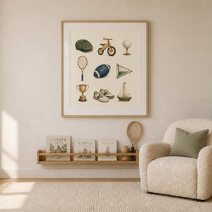 May include: A framed wall art print featuring a grid of nine illustrations including a green cap, wooden balance bike, golf ball, tennis racket, blue football, triangular flag, gold trophy, white sneakers, and a small sailboat on a cream background.