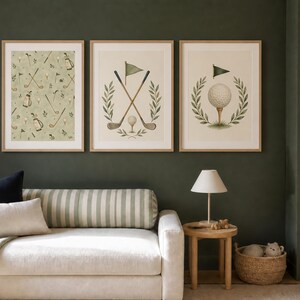 May include: Three framed wall art prints featuring golf-themed illustrations. The left print shows a repeating pattern of golf clubs, bags, and flags. The center print displays crossed golf clubs and a flag. The right print shows a golf ball on a tee.