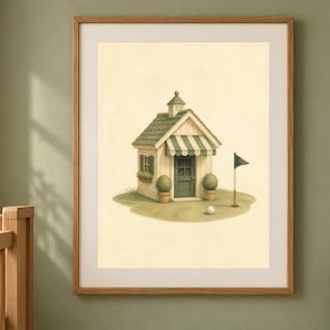 May include: A framed wall art print featuring a small, cream-colored shed with a green roof, a striped awning, and a dark green door. The shed sits on a patch of grass with two potted topiary plants, a golf flag, and a single white golf ball.