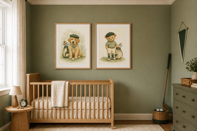 May include: Two framed wall art prints featuring watercolor illustrations of a golden retriever puppy and a teddy bear, both dressed in golf attire with caps and golf bags, displayed in light wood frames above a wooden crib in a nursery.