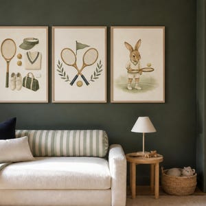 May include: Three framed wall art prints featuring tennis themes. The first shows a racket, visor, sweater, shoes, and bag. The second displays two crossed rackets with a flag and laurel leaves. The third depicts a rabbit holding a tennis racket.