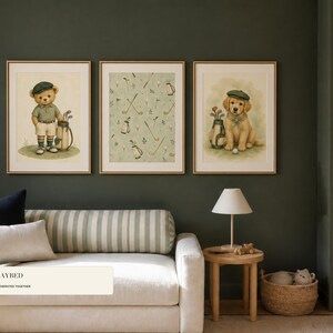 A striped sofa sits below three framed golf art prints on a dark green wall.