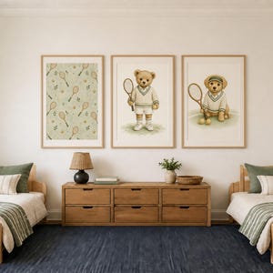 May include: Three framed wall art prints featuring a tennis theme. The left print shows a pattern of tennis rackets and balls. The center print depicts a teddy bear in tennis attire holding a racket. The right print shows a puppy in a visor.
