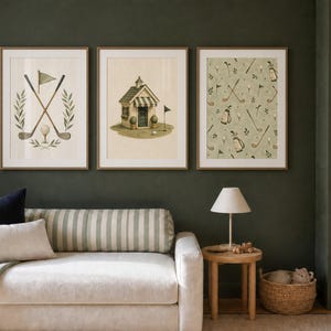 May include: A set of three framed wall art prints featuring golf-themed illustrations. The first print shows crossed golf clubs and a ball, the second a small golf clubhouse, and the third a repeating pattern of golf bags, clubs, and balls.