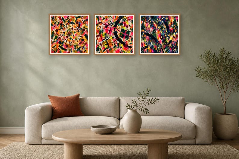 A staged living room with a beige sofa, a wooden coffee table, a potted plant, and three square abstract paintings hung on a green wall.