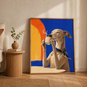 A framed art print of a dog drinking coffee leans against a beige wall beside a sofa and side table in a room.