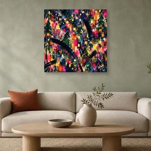 A square abstract artwork hangs on a textured sage green wall above a beige sofa, wooden coffee table, and potted plant.