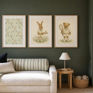 May include: Three framed wall art prints featuring tennis themes. The left print shows a pattern of tennis rackets and leaves. The center print depicts a rabbit in tennis attire holding a racket. The right print shows a teddy bear in tennis gear.