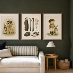 May include: Three framed wall art prints featuring golf-themed illustrations. The left print shows a golden retriever puppy with a golf bag, the center print displays golf equipment, and the right print depicts a teddy bear dressed in golf attire.