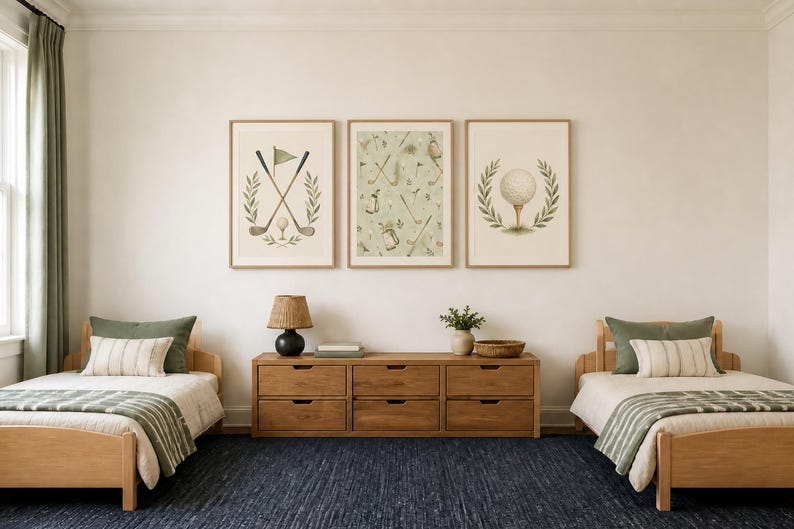 Two twin wooden beds with green bedding flank a long wooden dresser beneath three framed golf art prints hanging on a neutral wall.