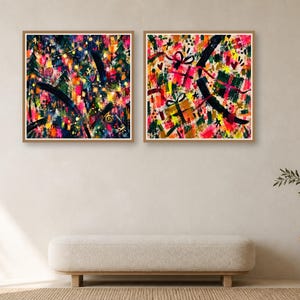 Two framed square abstract art prints featuring colorful expressive strokes displayed on a wall above a modern upholstered bench.