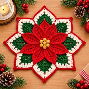May include: A star-shaped crochet doily featuring a central red poinsettia flower with yellow textured beads at the center. The design includes layers of dark green leaves and white scalloped edges, creating a festive, multi-layered floral pattern.