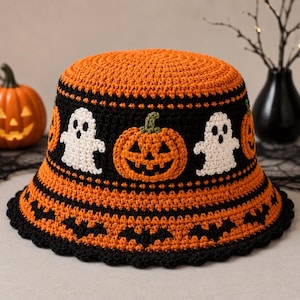 May include: A crochet bucket hat featuring a vibrant orange top and a black band decorated with white ghost motifs and orange jack-o'-lanterns. The brim is orange with a black border featuring a repeating pattern of small black bats.