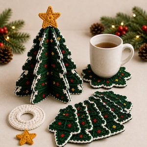 May include: A three-dimensional crocheted Christmas tree with a yellow star topper, accompanied by a stack of matching tree-shaped coasters, a white circular coaster, a separate yellow star, and a white ceramic mug resting on a coaster.