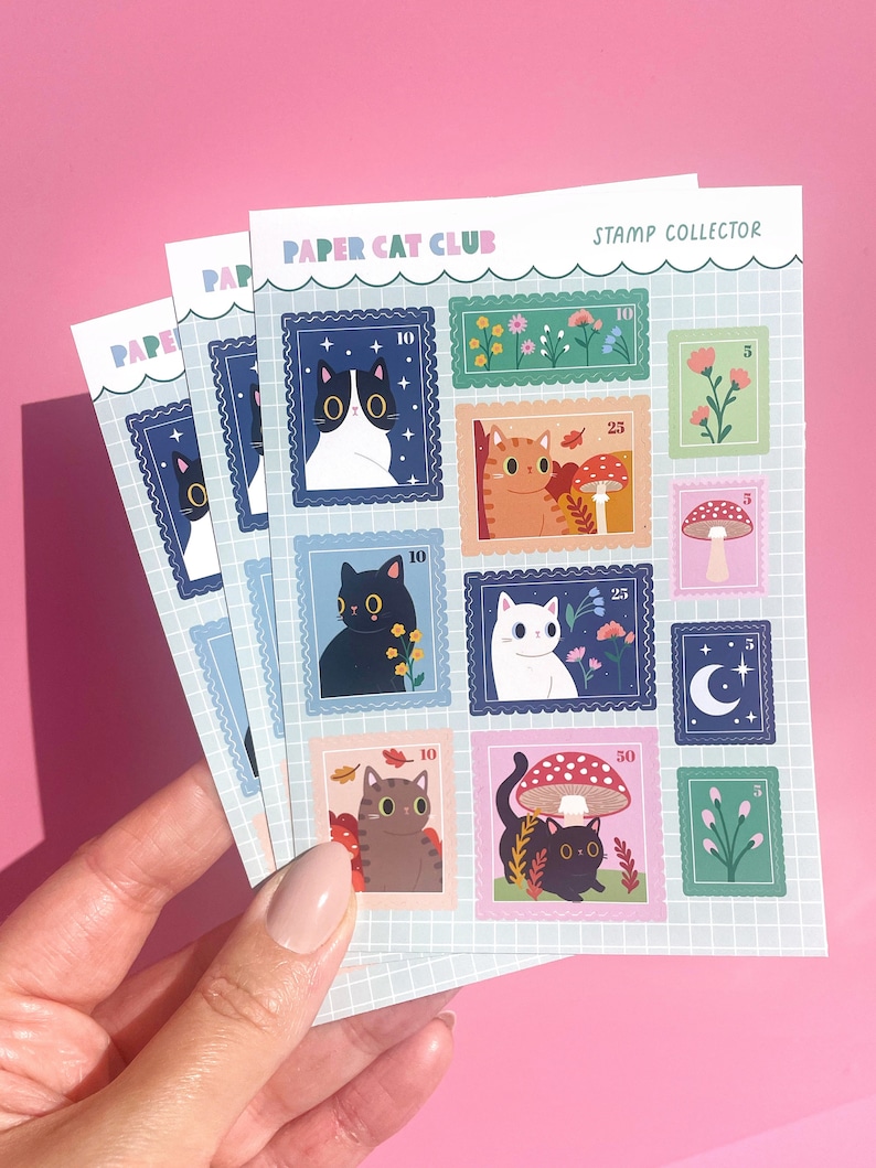 A rectangular A6 sheet of matte stickers featuring various designs of cats nestled among wildflowers, styled as postage stamps.