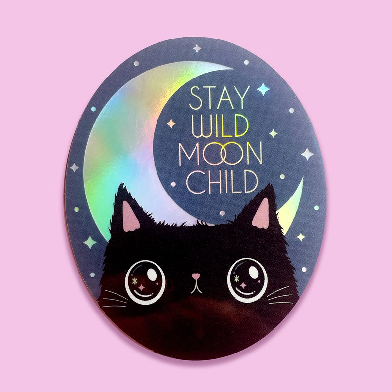 May include: A black cat with large eyes sits in front of a crescent moon with a holographic finish. The moon has the text "Stay Wild Moon Child" on it.