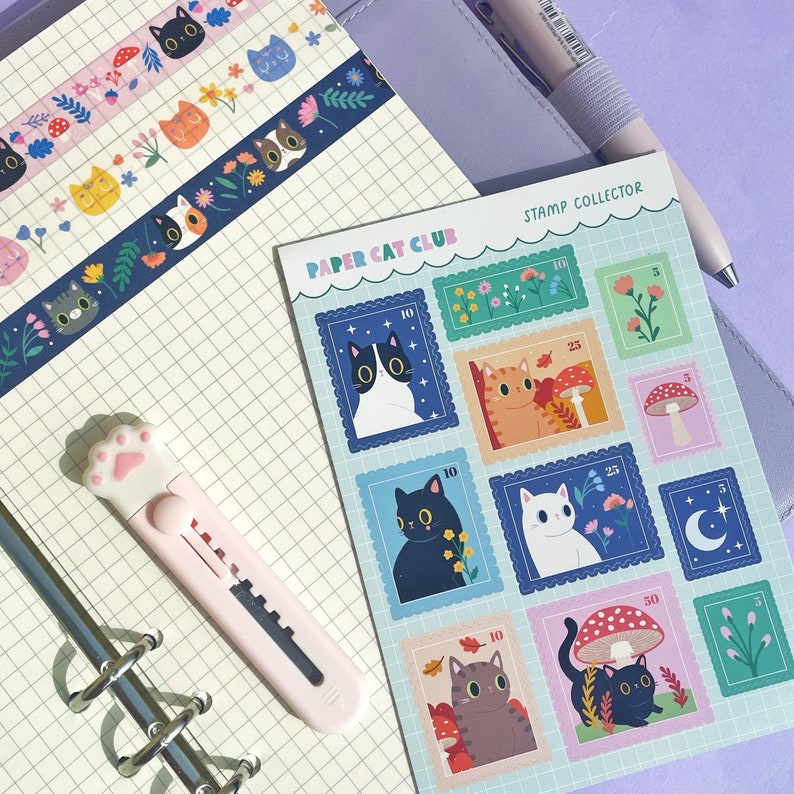 May include: A set of colorful paper cat club stamps with illustrations of cats, mushrooms, and other whimsical designs. The stamps are labeled with different values, such as 10, 25, and 50. The text "STAMP COLLECTOR" is printed at the top of the sheet.