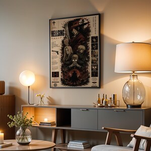 May include: A framed Hellsing poster featuring dark, detailed character illustrations and Japanese text, displayed on a wall above a gray console table. The artwork includes a central figure in a red coat, a handgun, and various smaller character portraits.